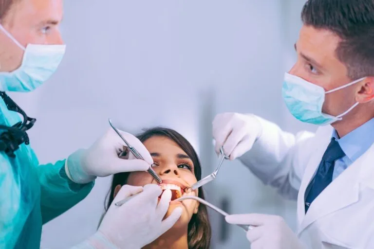 dentists working with young female patient 7H3PK62