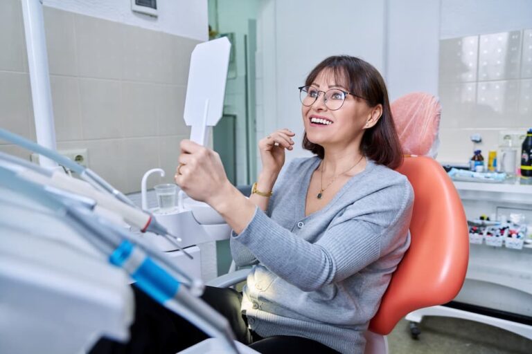 smiling middle aged woman in dental chair with mir 2022 05 25 00 32 36 utc 1