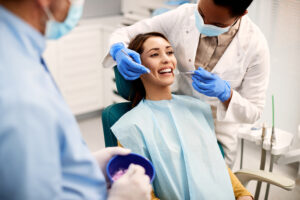 happy woman getting her teeth examined by african 2023 11 27 05 34 10 utc